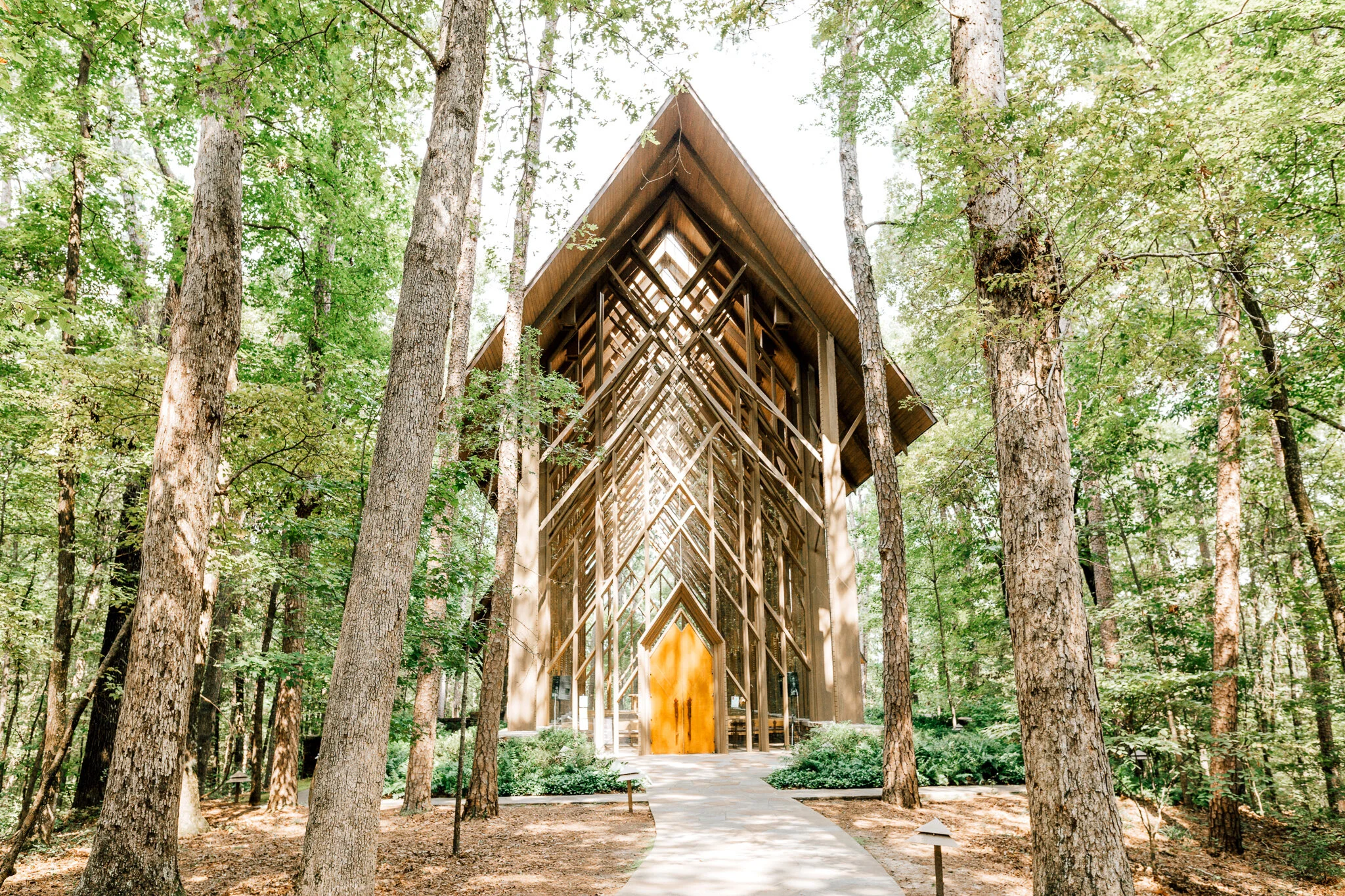 Peaked wooden chapel in a forest setting